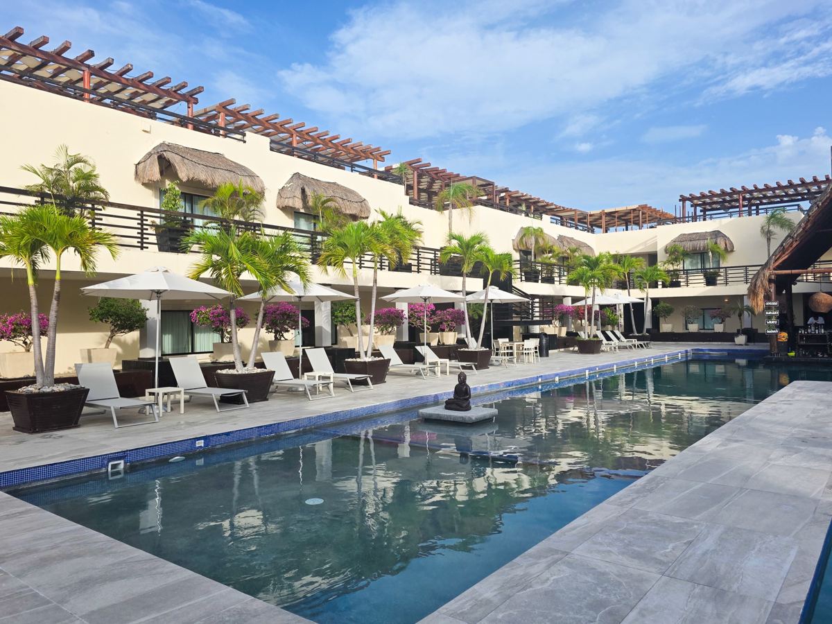 The Village Pool, with loungers and umbrellas the length of the deck