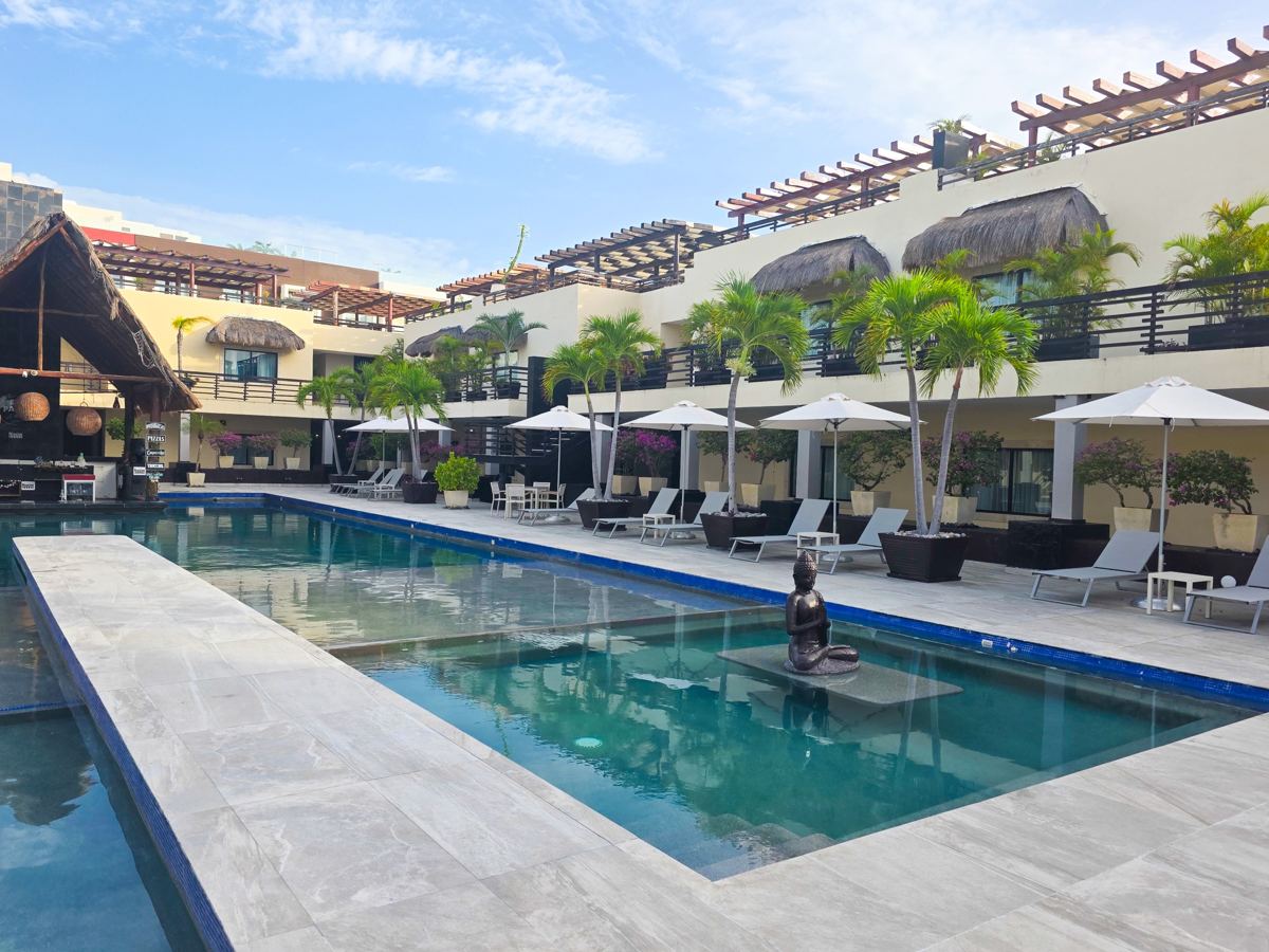 The Village Pool, its swim-up bar and the great palapa at the far end