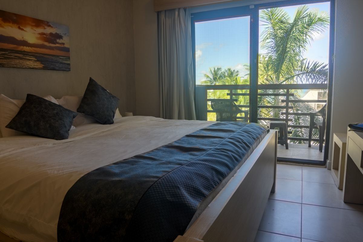 The main bedroom, with a king bed and a door to the terrace
