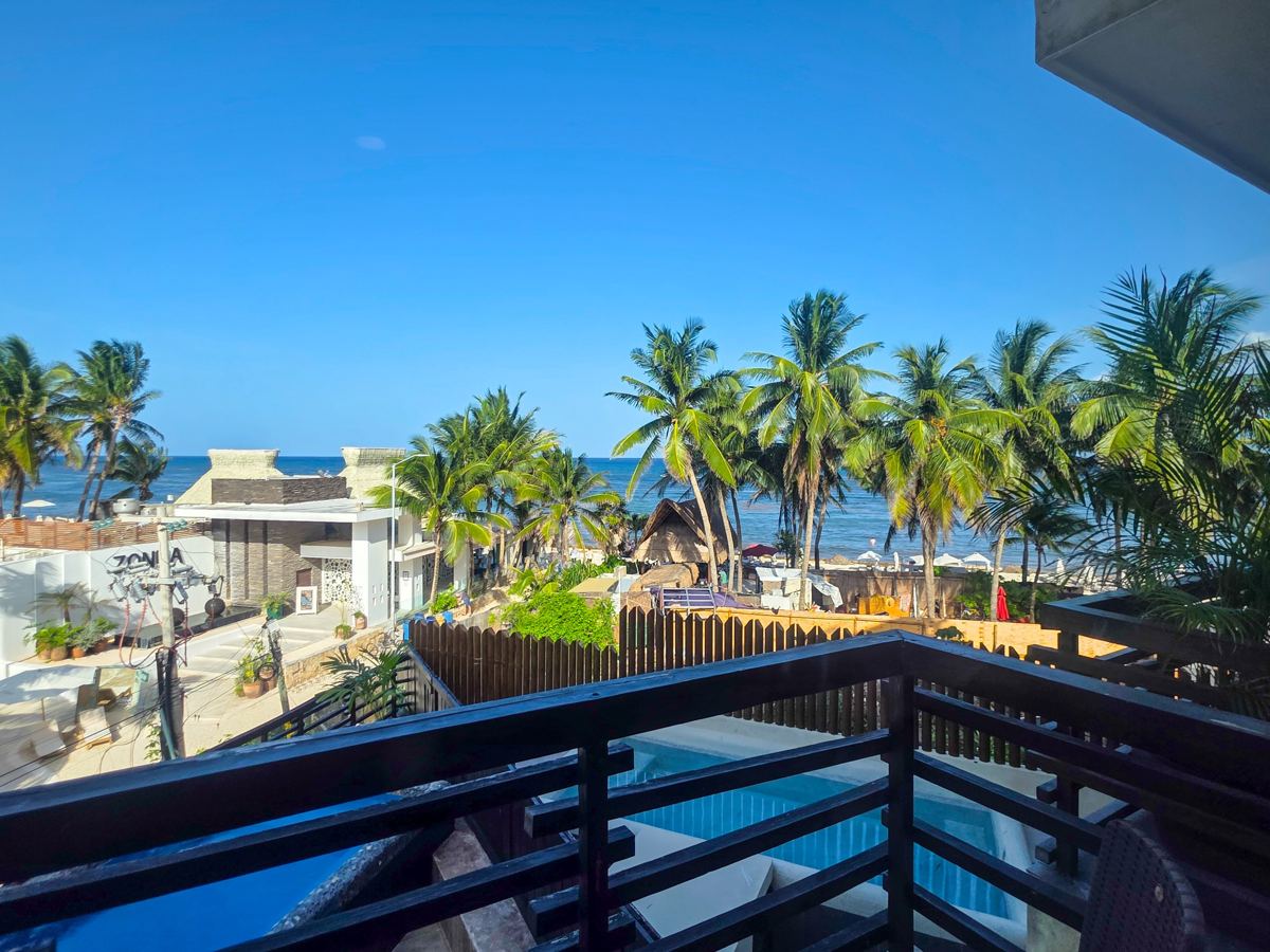 The view from the terrace, over the palms and the pool to the Caribbean